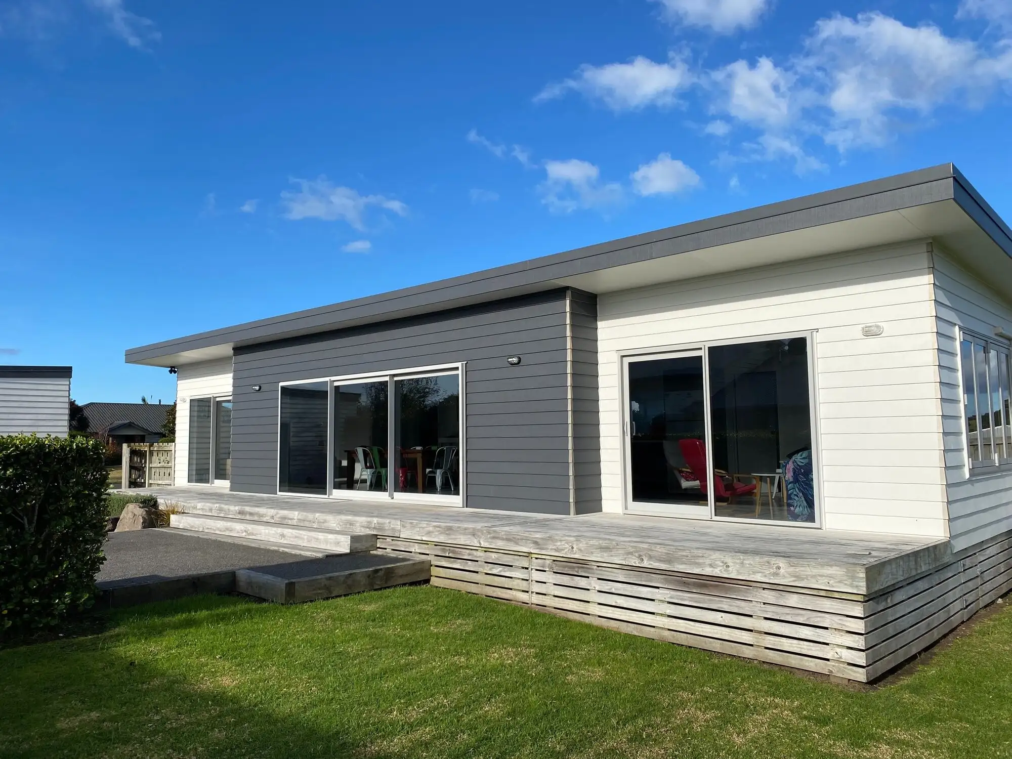 White weatherboard house at Waihi Beach painted by Pail Painting
